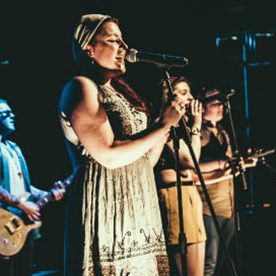 female signers performing on stage 