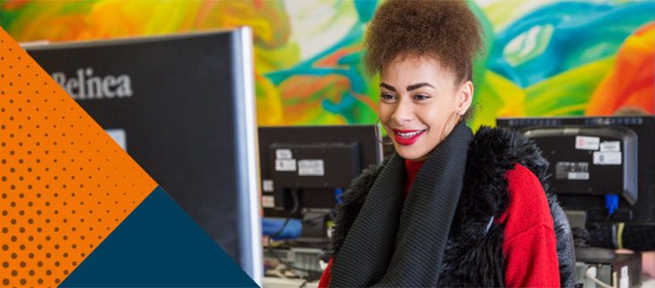 Business student looking at computer with orange,dark blue triangles