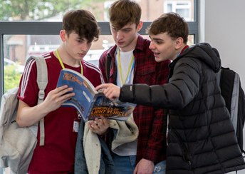 students looking at a book
