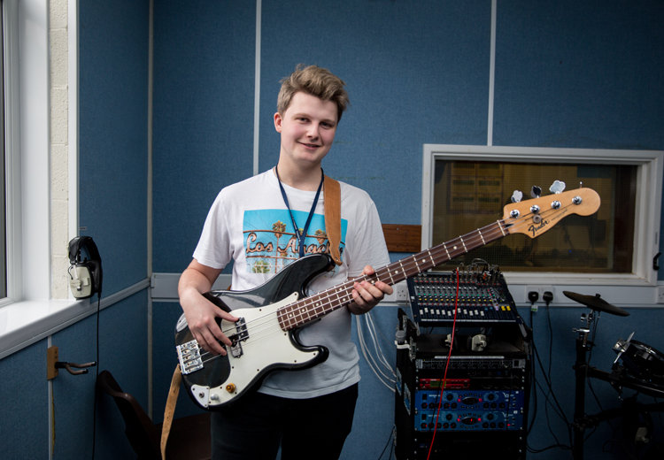 male guitarist in recording studio