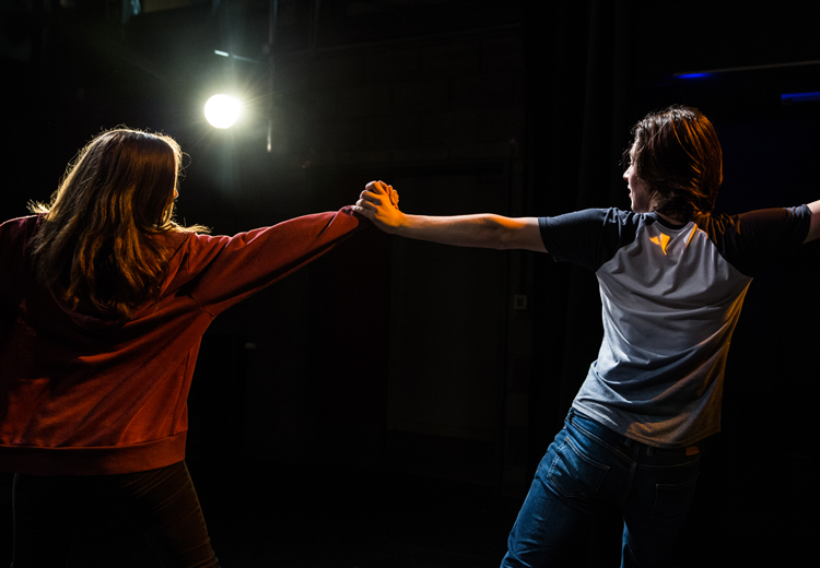 2 students performing on stage