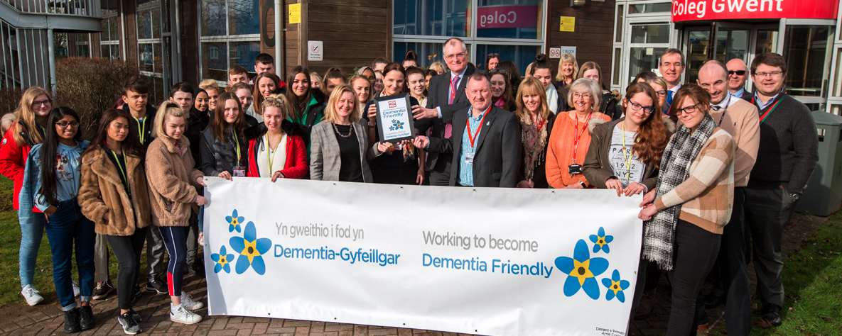 staff and students holding Dementia Banner