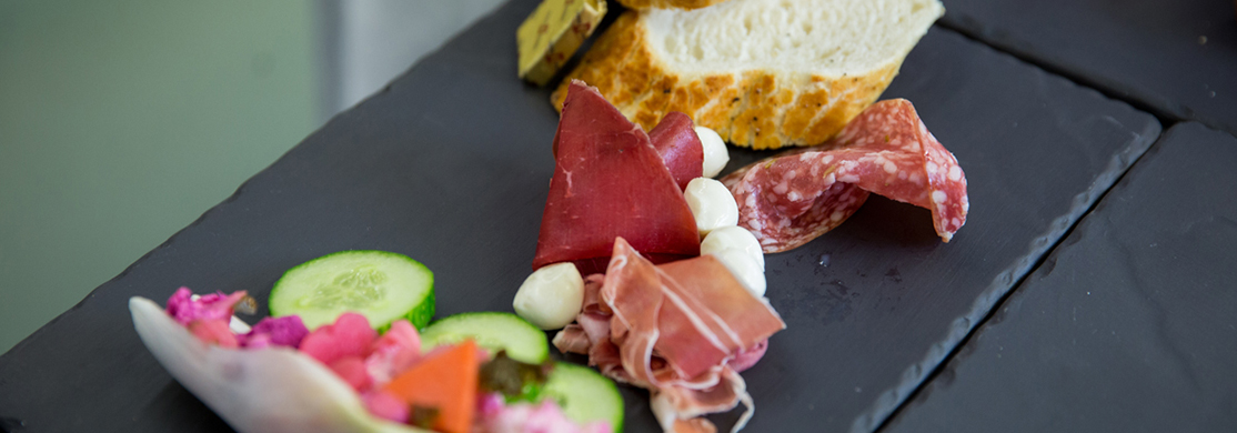 restaurant-food Charcuterie and salad on a slate platter
