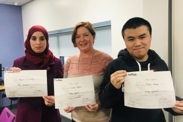 Three Coleg Gwent Students proudly showing their Tafflab honorary certificates.