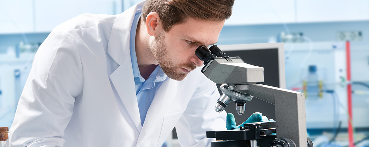 Man looking through microscope