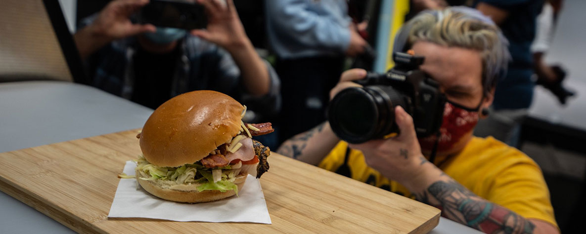 Photography learner taking photo of a burger