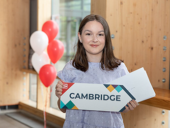 Alicia Powell holding a Cambridge sign