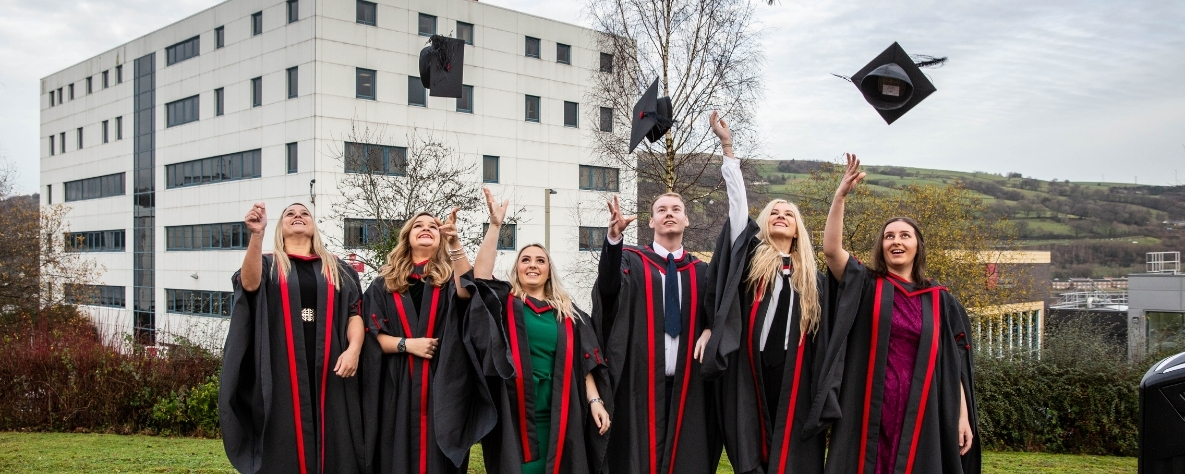 University students throwing their graduation caps in the air