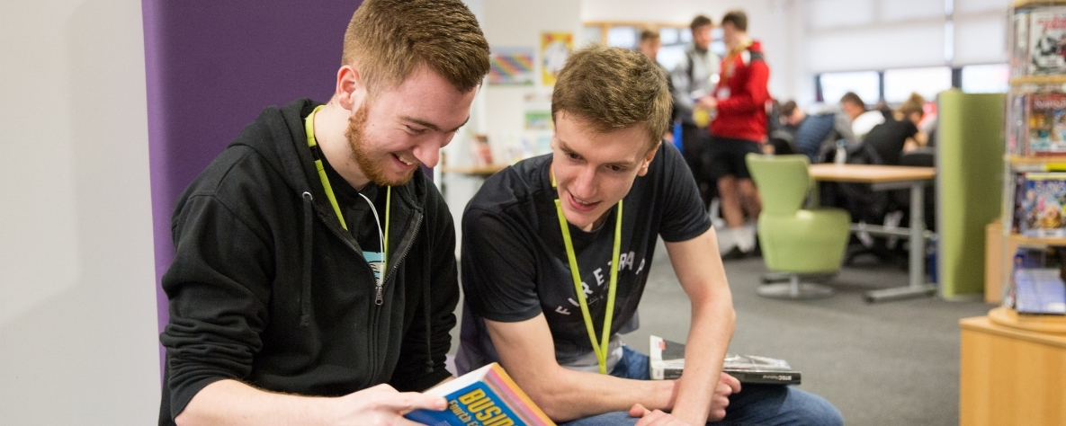 Two students studying in the library