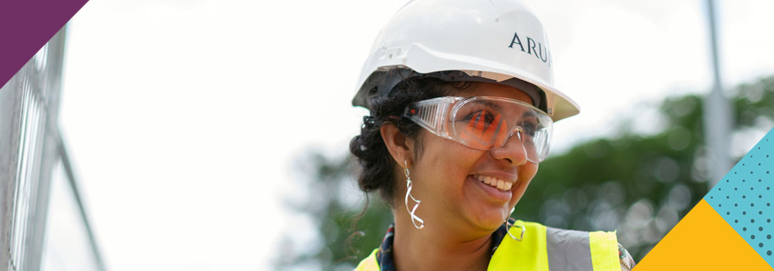 health-safety-sector-header Woman in hard hat, hi-viz and safety glasses