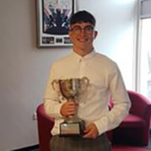 Learner Hywel Evans holding trophy