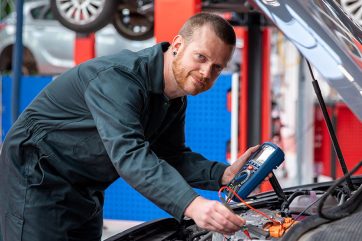 Man working under car bonnet