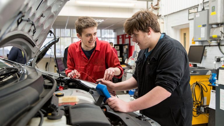 Learners repairing car