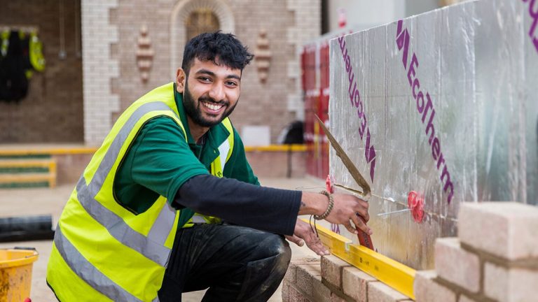 Learner laying bricks