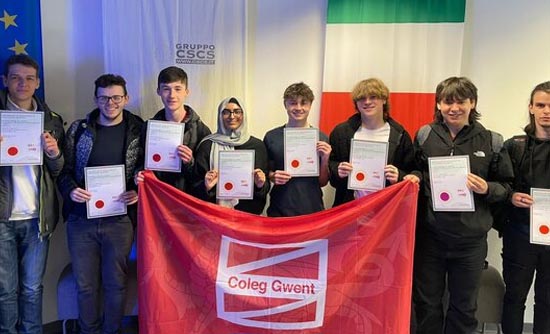 Students with certificates and Coleg Gwent flag