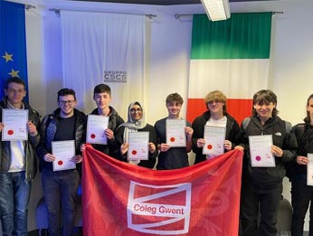 Students with certificates and Coleg Gwent flag