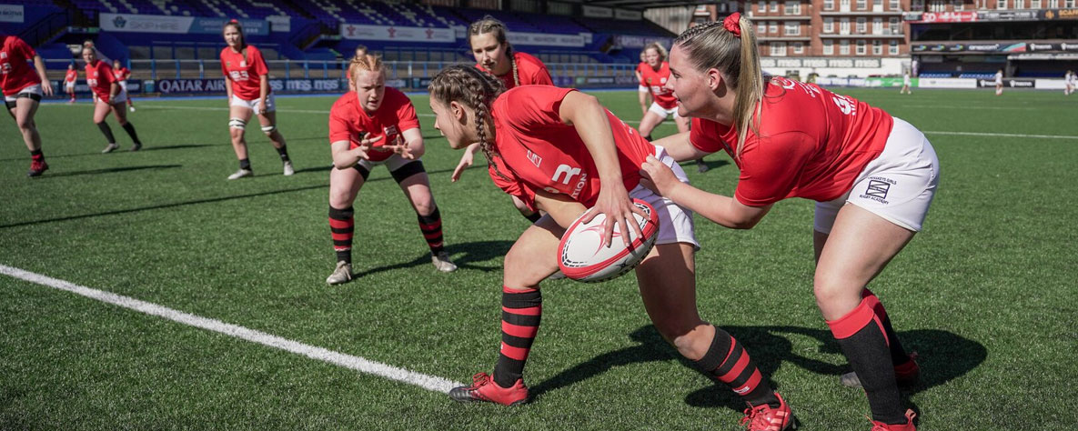 Coleg Gwent women's rugby team passing ball