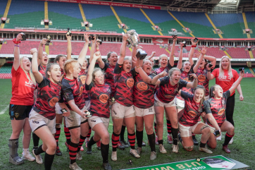 Coleg Gwent women's rugby team celebrating with cup