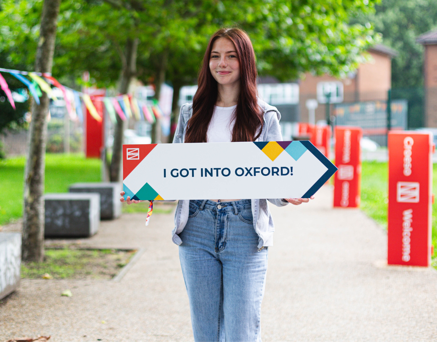 Learner holding uni sign