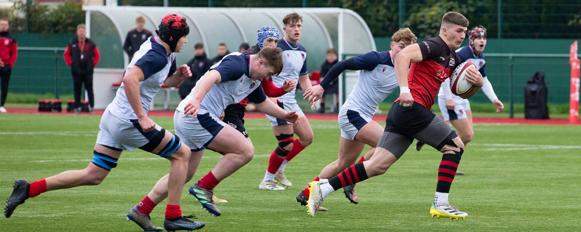 Dragons academy player running with ball