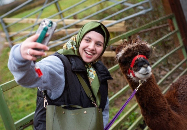 Coleg Gwent student posing with llama