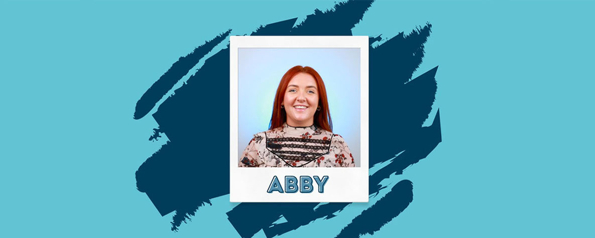 Polaroid photo of Abby on blue background
