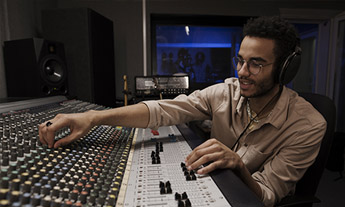 Person using an audio mixing desk