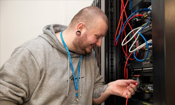 Student examining a network switch