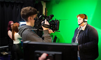 Students with camera using a green screen