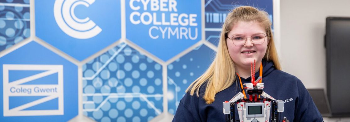 Cyber College Cymru student holding a robot