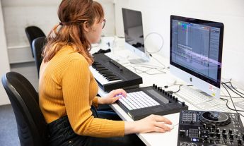 Coleg Gwent student creating music on a Mac computer