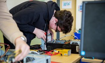 Coleg Gwent student repairing a PC