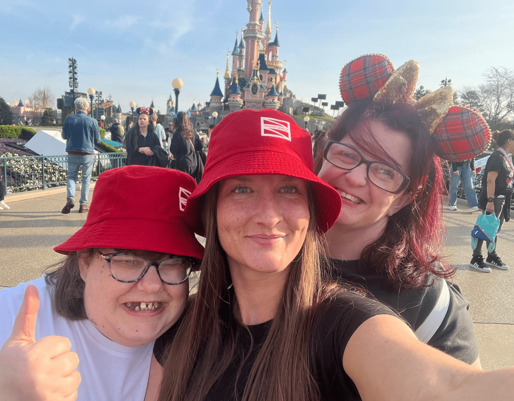 Three women smiling at screen