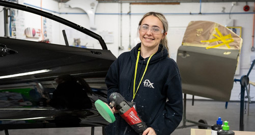 Apprentice in car body repair workshop