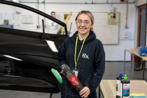 Apprentice in body repair workshop