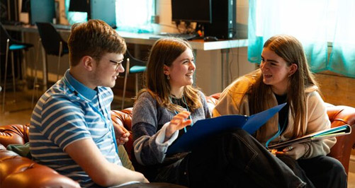 Students sitting in HE Hub