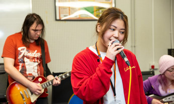 Music students singing and playing guitar