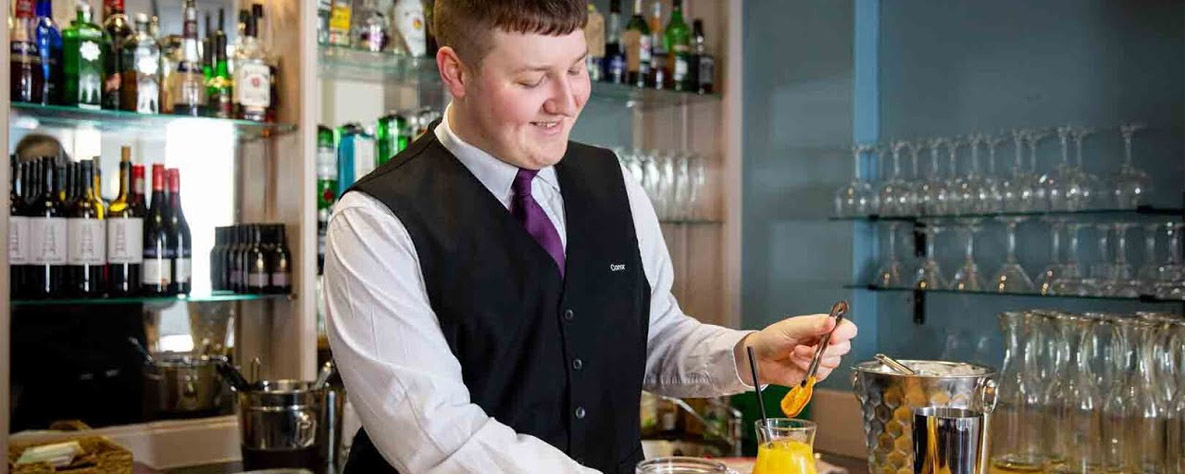 Student working in a bar