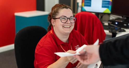 Staff member helping at reception