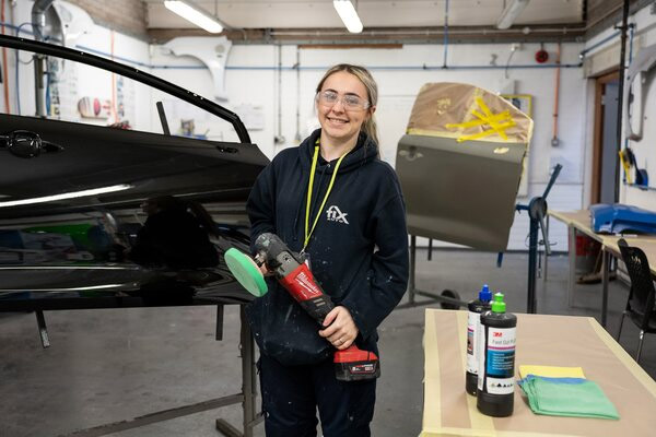 Apprentice in car body repair workshop