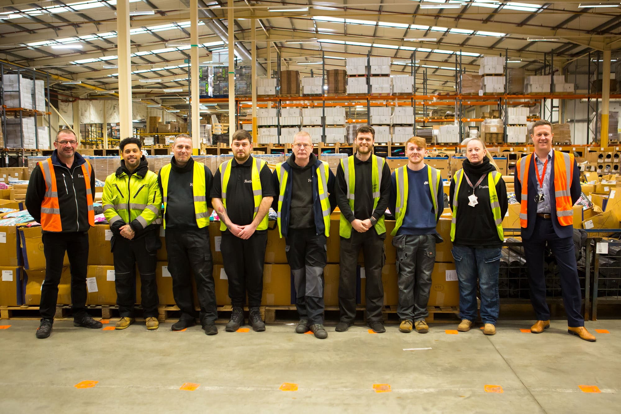 A group of learners in construction uniform including hi-vis jackets.