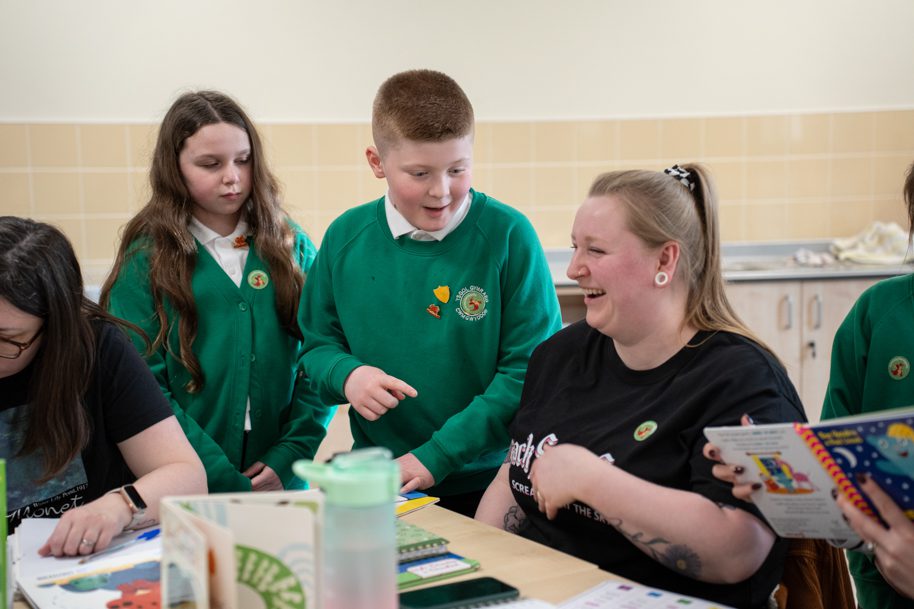 Parent learning Welsh with children at school