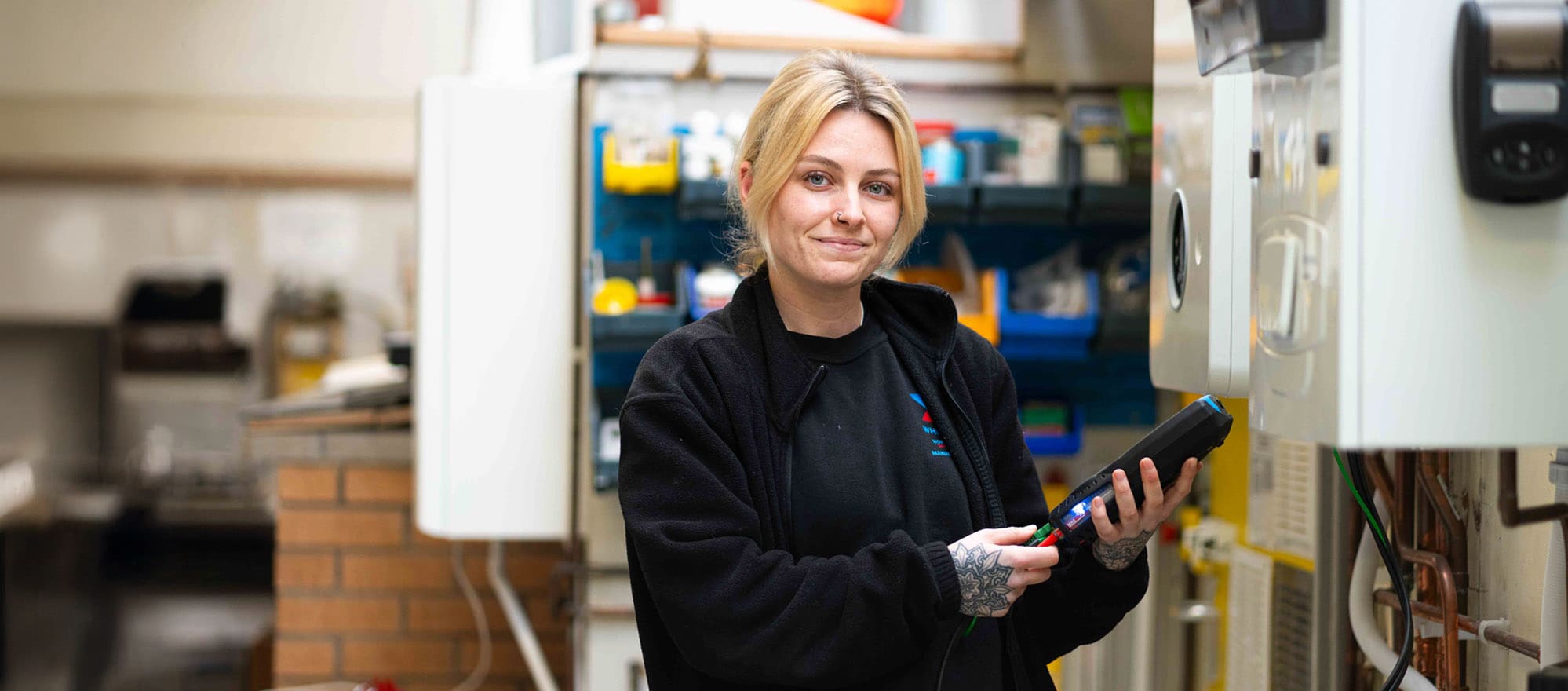 Apprentice Plumber in plumbing bay with kit