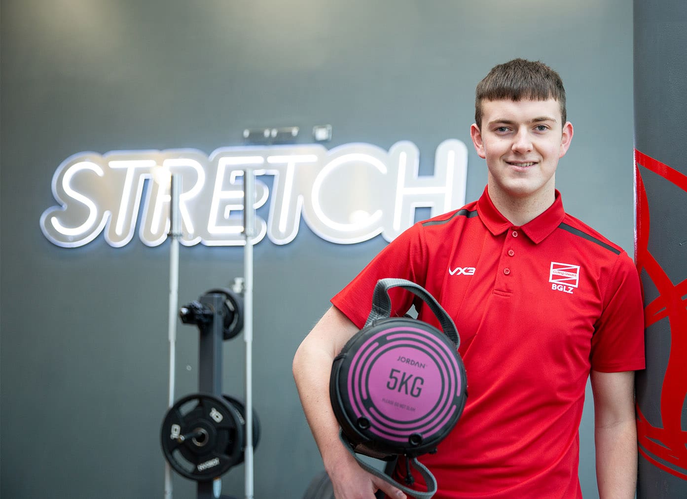 Sport student in the gym holding weights