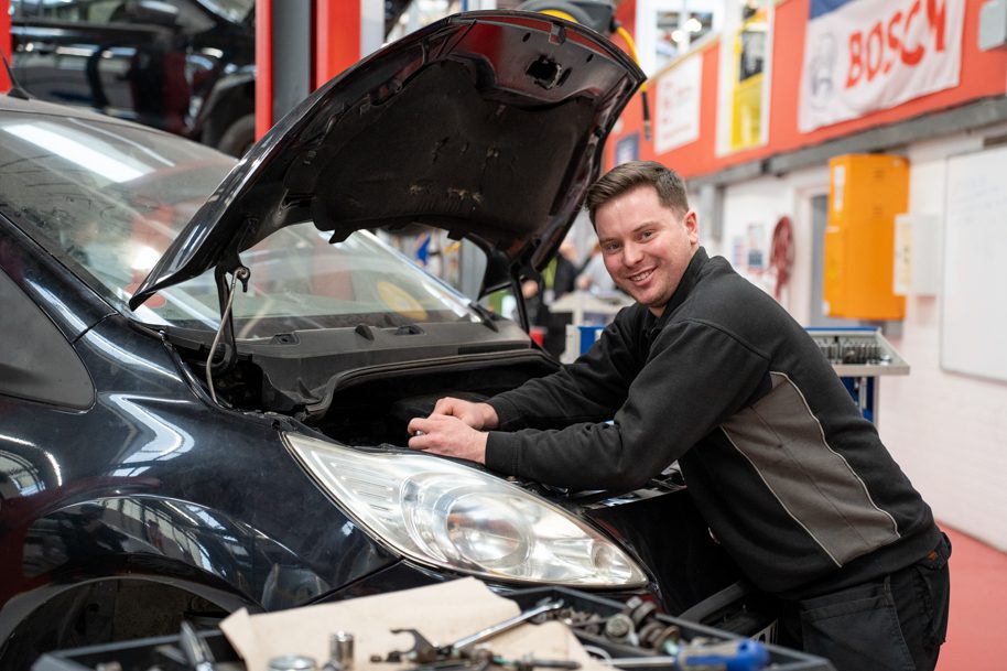 Student in vehicle repair