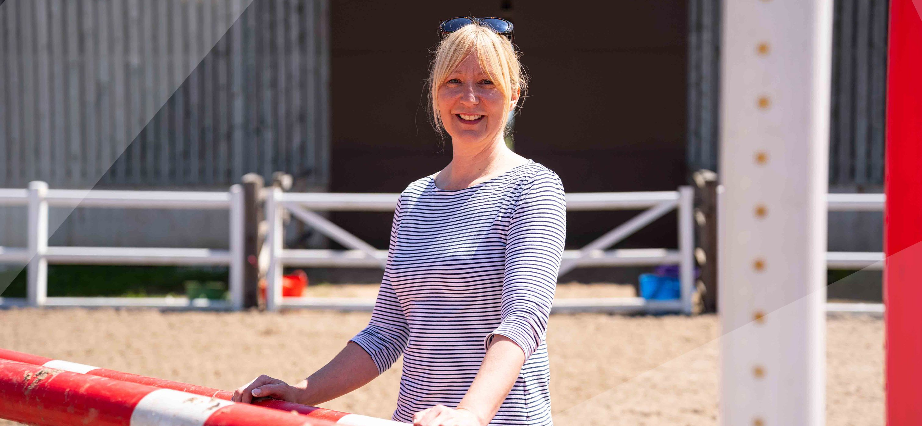 Student standing in the sun at the equestrian centre