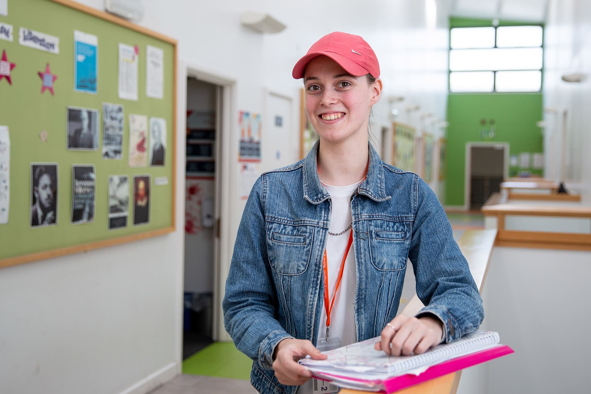 Student smiling in pink cap at Crosskeys Campus