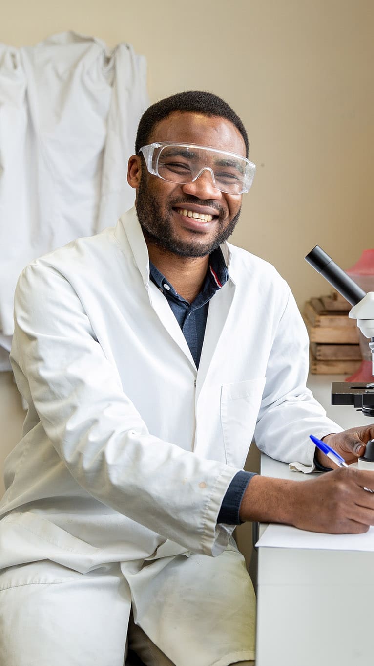 Student using microscope in classroom