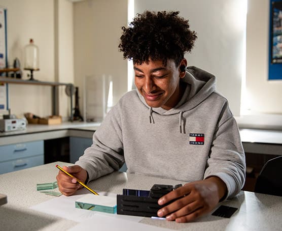 Young student doing science experiment in lab