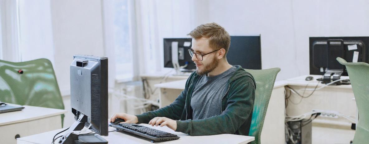 Young professional sat at desk using computer
